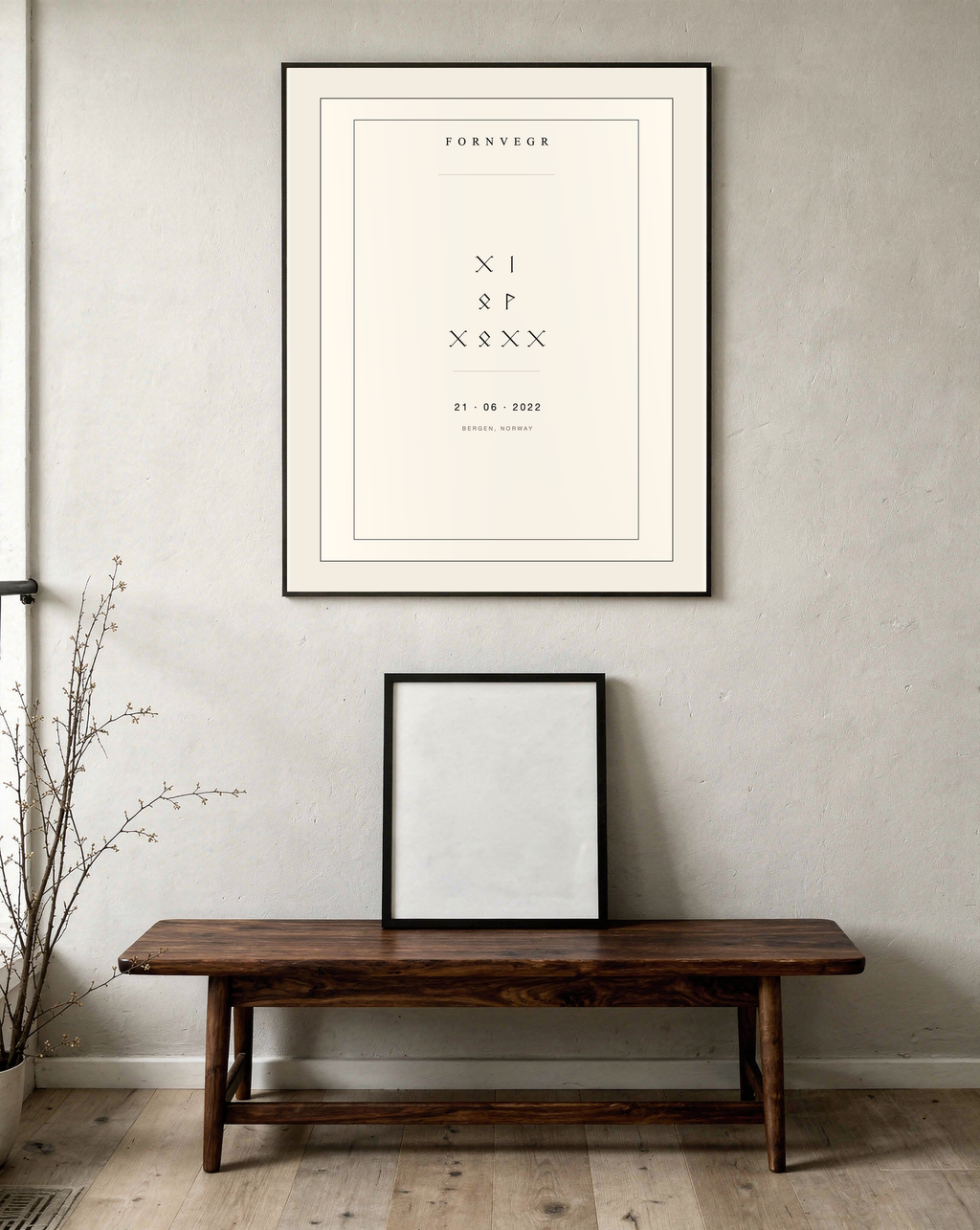 Runic birth marker in a black frame on a hallway wall above a dark wooden bench