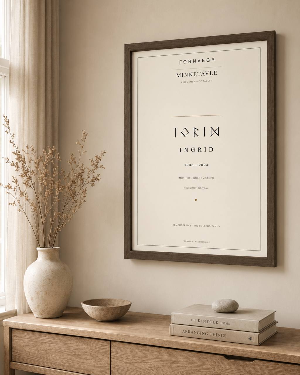 Minnetavle personalized Nordic remembrance tablet in a dark wood frame above a Scandinavian sideboard